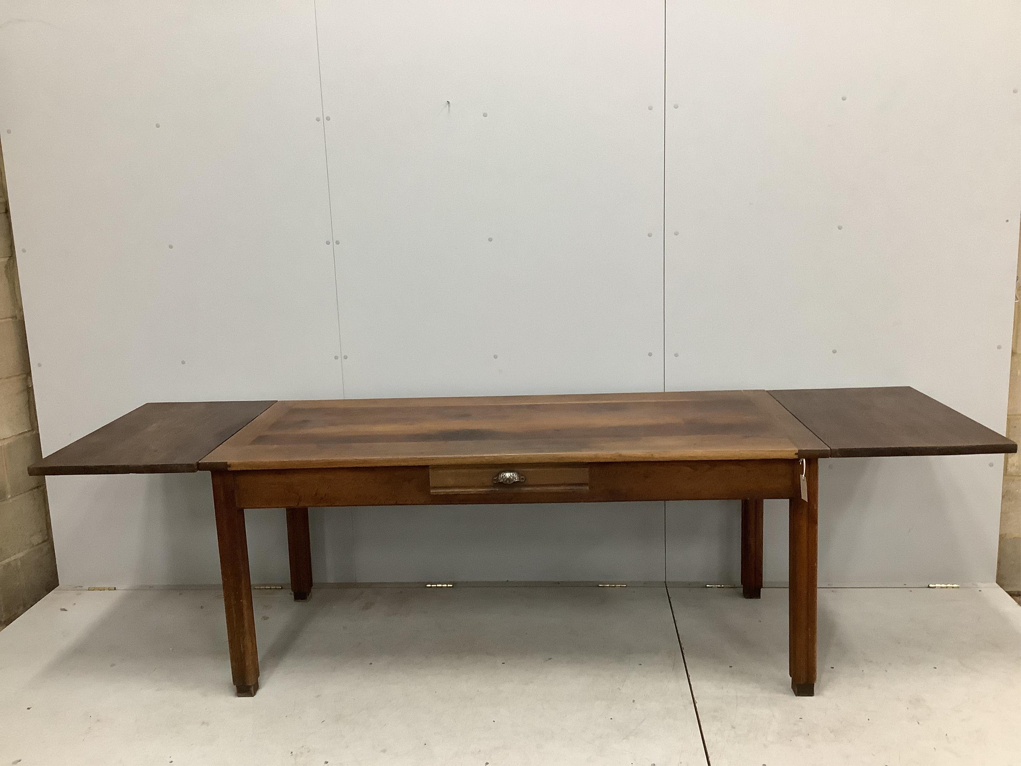 A French rectangular oak farmhouse kitchen table with detachable extension leaves and a single drawer, width 179cm, 277cm extended, depth 79cm, height 77cm. Condition - fair to good